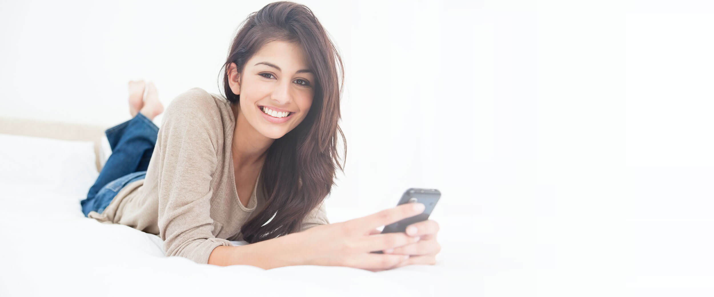 girl smiling holding phone